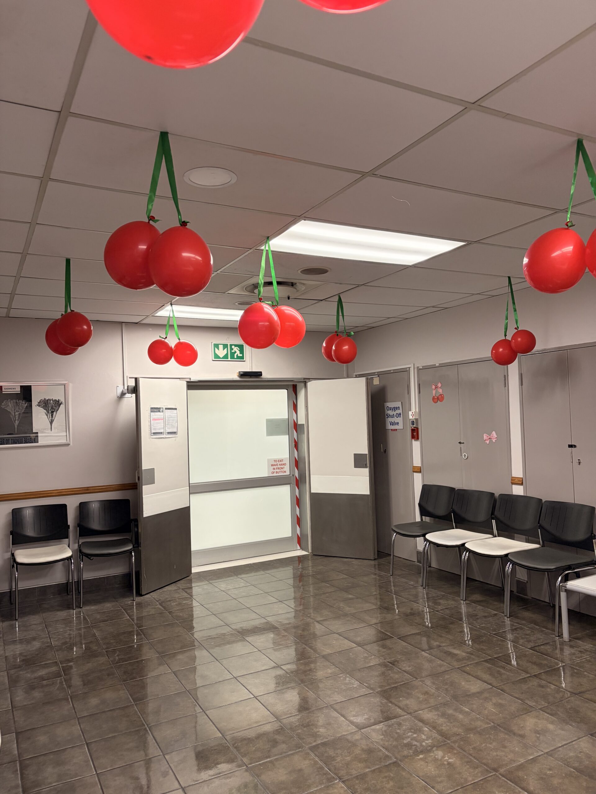 ImagePro Radiology waiting area with red balloons suspended from green ribbons above patient seating