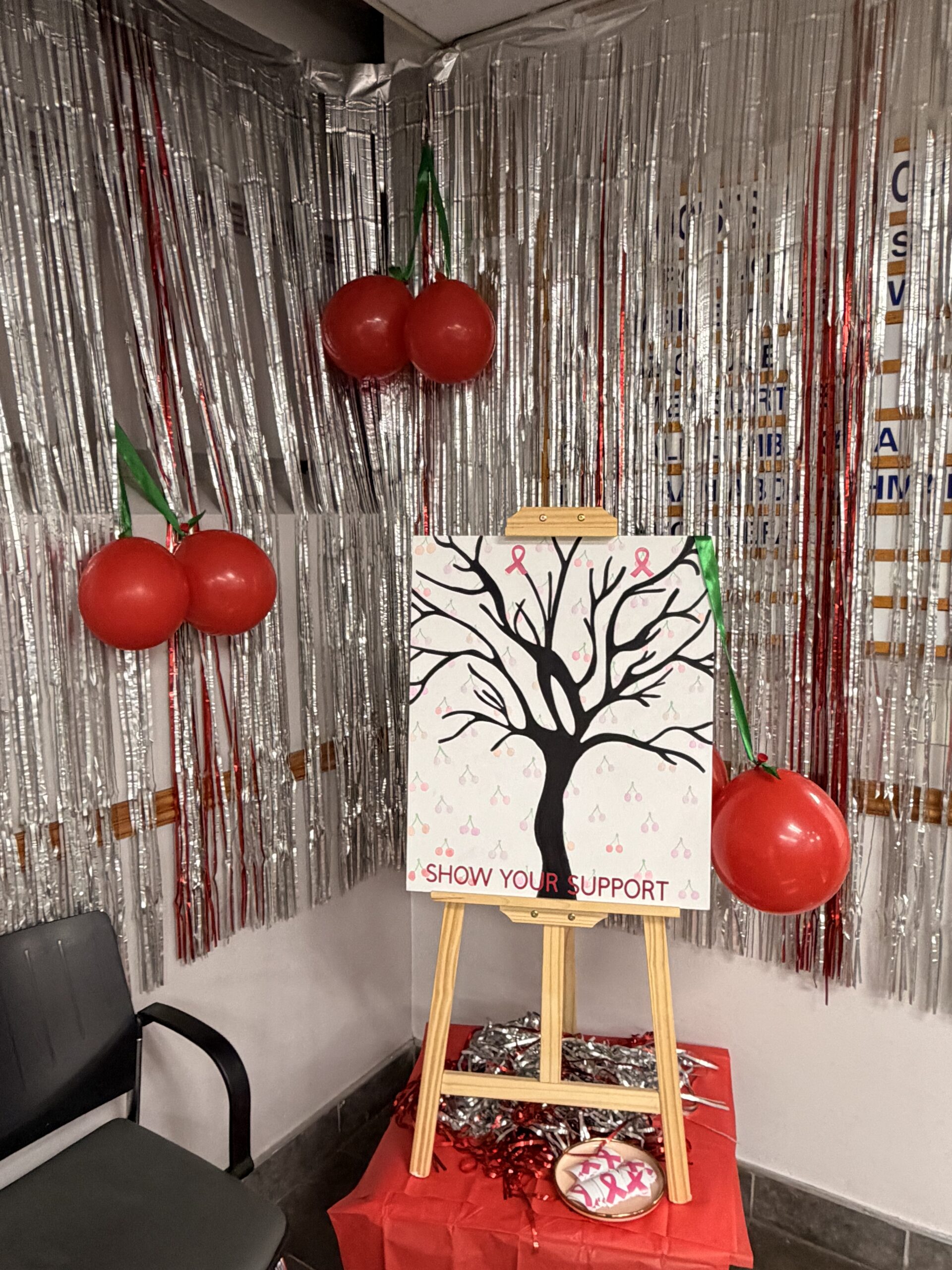 Show your support tree displayed on an easel, surrounded by silver streamers and red balloon decorations at ImagePro Radiology